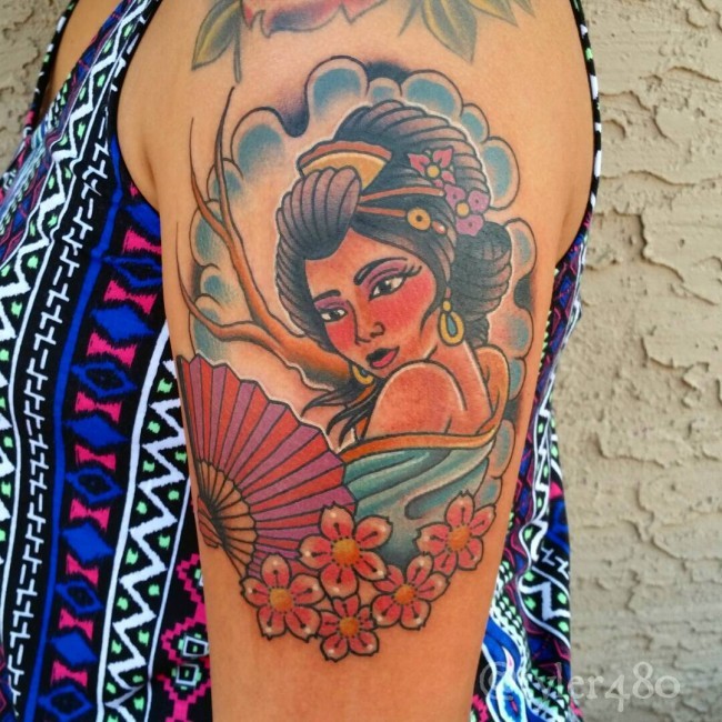 Tatuaje en el brazo, geisha atractiva con abanico y flores
