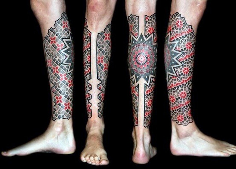 Beautiful painted and colored ancient ornament tattoo on leg