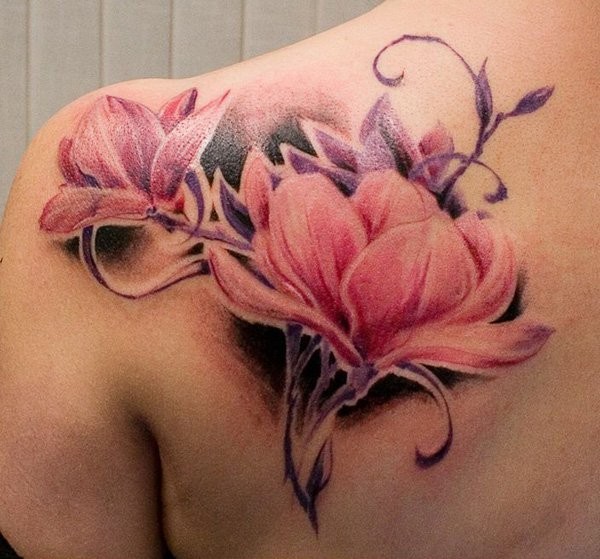 Beautiful painted and colored natural looking scapular tattoo of big flowers