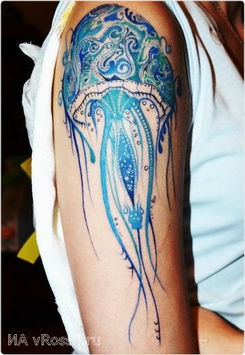 Beautiful painted and styled multicolored jelly-fish tattoo on shoulder