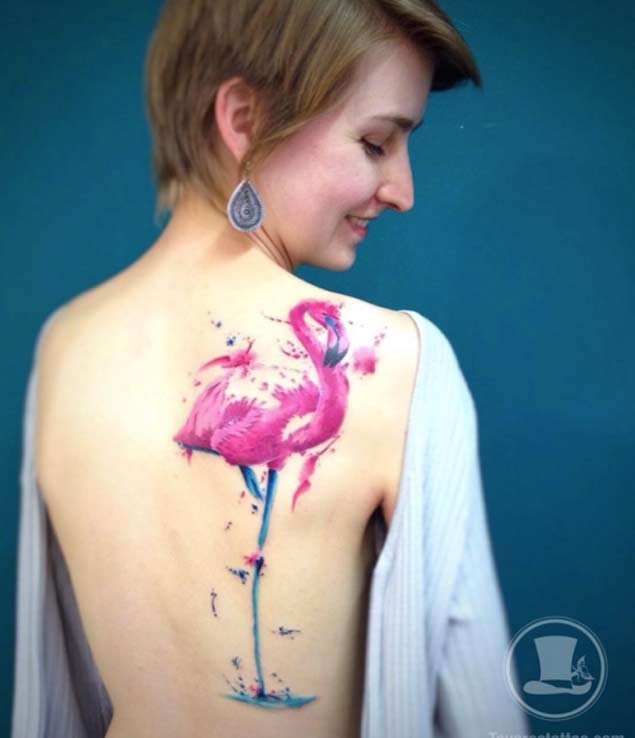 Beautiful painted big colored flamingo tattoo on back