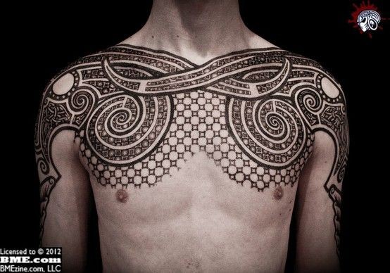 Beautiful painted black and white geometrical tattoo on chest and shoulders