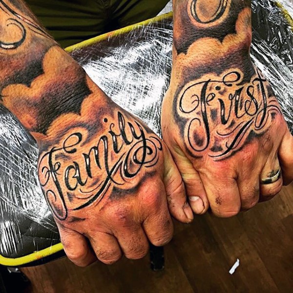 Beautiful painted black and white lettering tattoo on hands