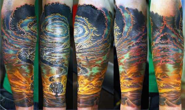Beautiful painted colorful mystical clouds tattoo on sleeve
