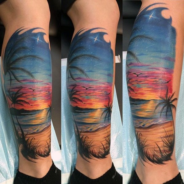 Beautiful painted colorful ocean beach with palm trees tattoo on leg