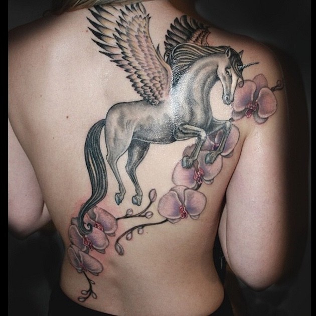 Beautiful painted very detailed flowers tattoo on back combined with unicorn