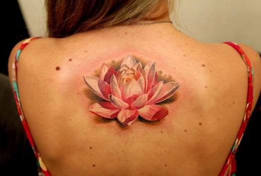 Beautiful pink white lotus tattoo on back by Dmitriy Samohin