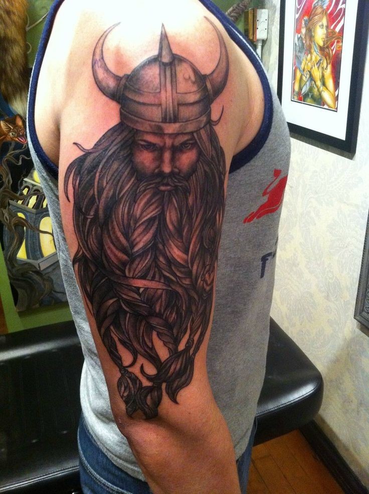 Beautiful viking with a thick beard tattoo on half sleeve