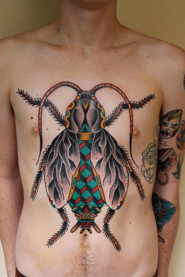 Beautiful vivid colors bug tattoo on chest and abdomen