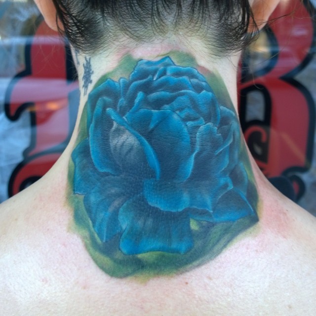 Big 3D like blue colored rose flower tattoo on neck