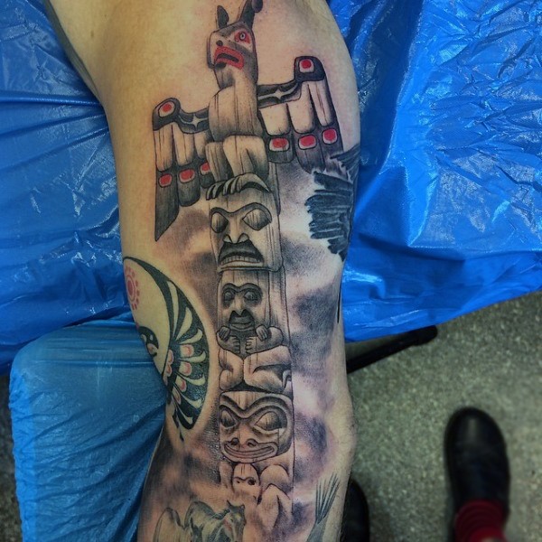 Big 3D like colored old tribal statue tattoo on arm