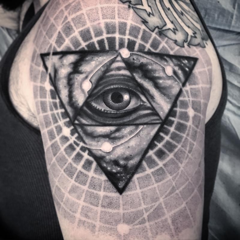 Big accurate painted in dotwork style shoulder tattoo of triangle with human eye