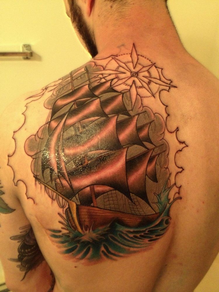 Tatuaje en el brazo, barco navega en el mar a toda velocidad