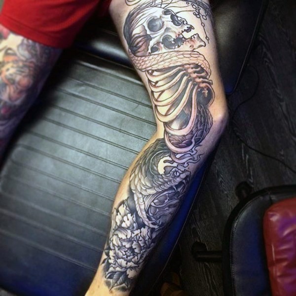 Big black and white detailed skeleton with snake tattoo on leg