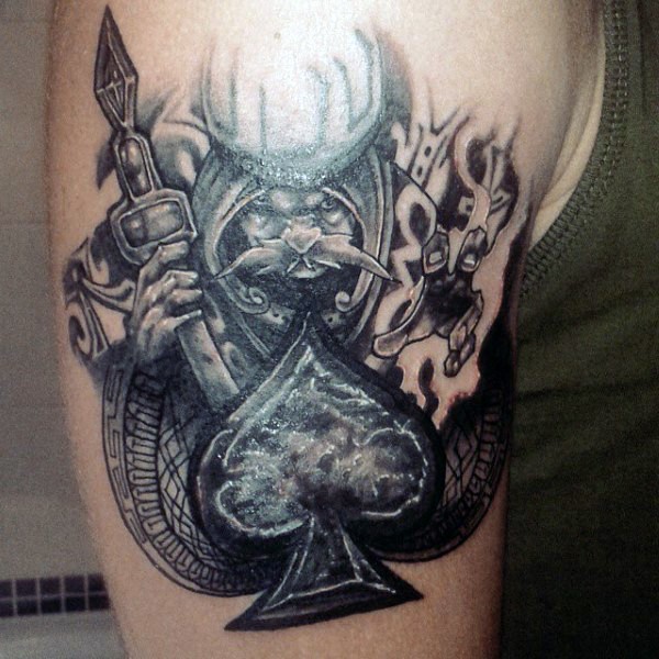 Big black and white fantasy wizard with spades symbol tattoo on upper arm