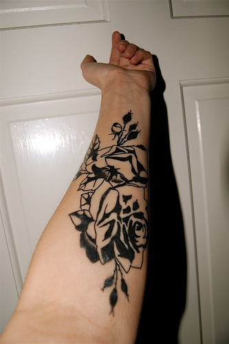 Big black and white flowers on inner side of hand