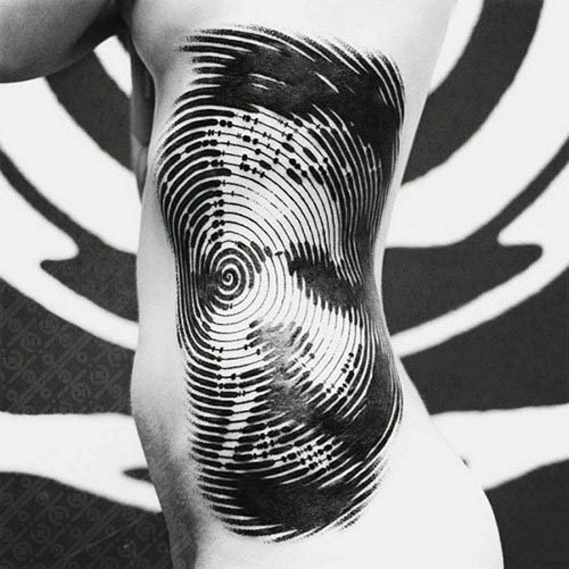 Big black and white hypnotic ornament tattoo on side