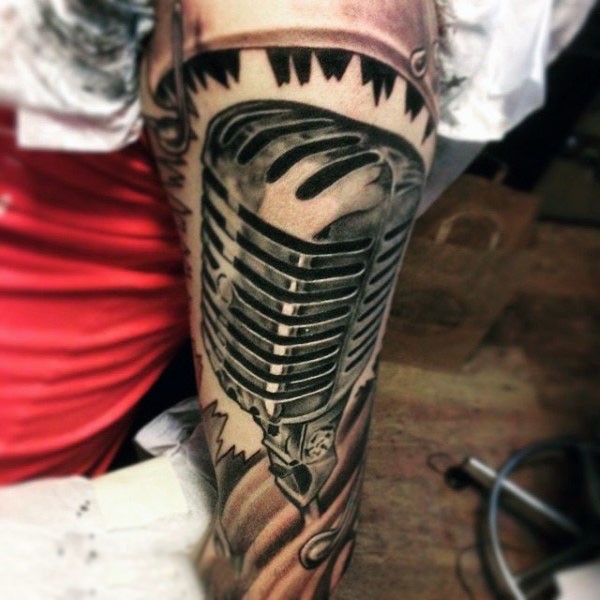 Big black and white microphone tattoo on arm