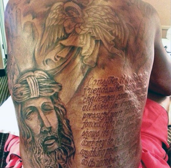 Big black and white religious tattoo with Jesus, angel and lettering on whole back