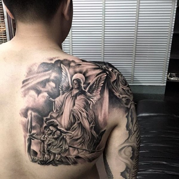 Big black and white shoulder tattoo of angel and kids