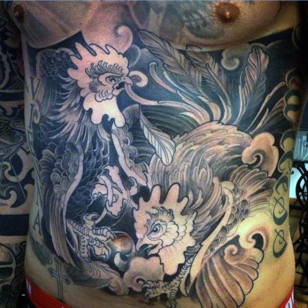 Big black and white very detailed cock fight tattoo on belly