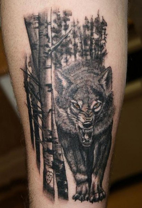 Big black ink colored angry wolf if forest tattoo