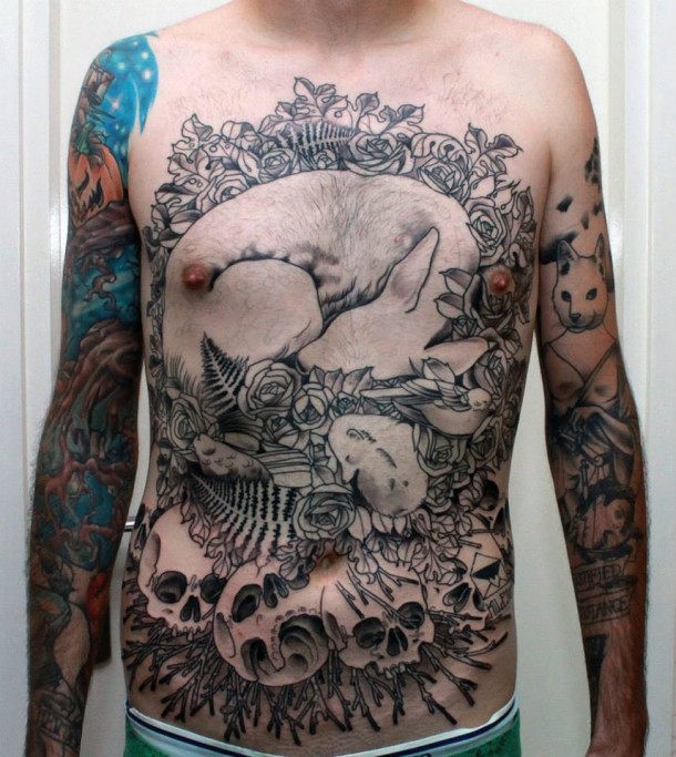 Big black ink detailed tattoo on whole chest and belly with sleeping fox with flowers and skull