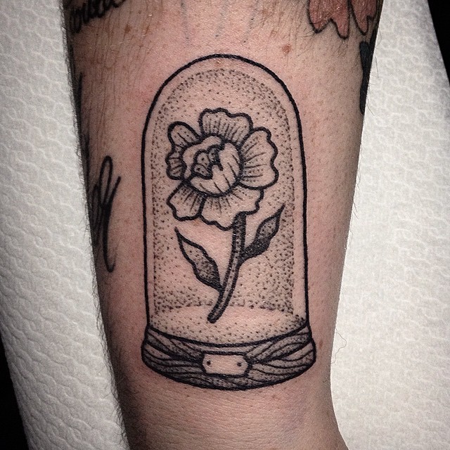 Big black ink flower tattoo on arm