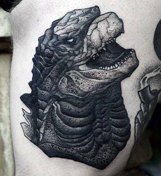 Big black ink Godzilla head tattoo on arm