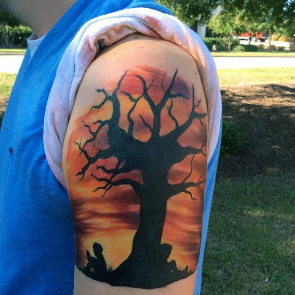 Big black ink lonely tree with children tattoo on shoulder