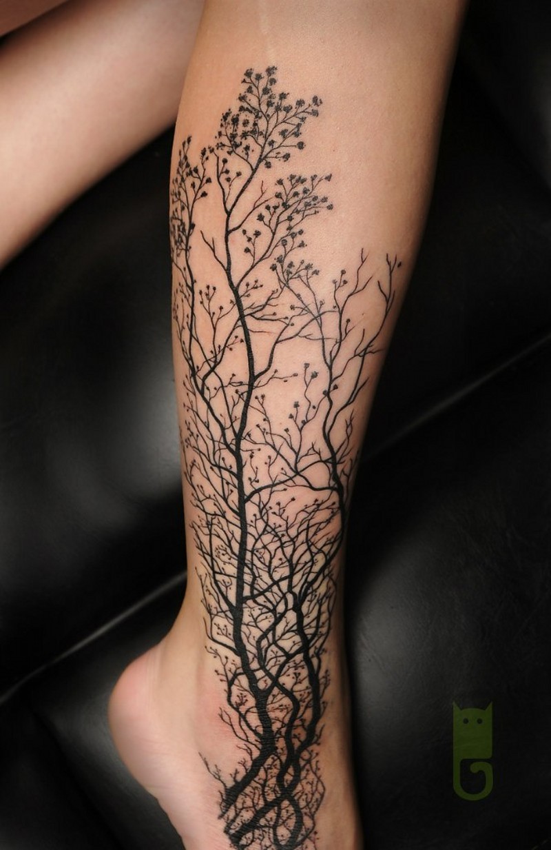 Big black ink realistic forest tattoo on ankle