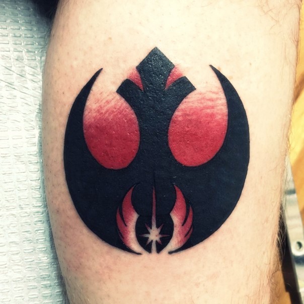 Big black ink Rebel emblem tattoo on leg stylized with cool Jedi emblem
