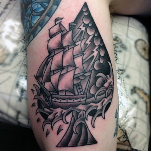 Tatuaje en el brazo, pica estilizada con barco precioso