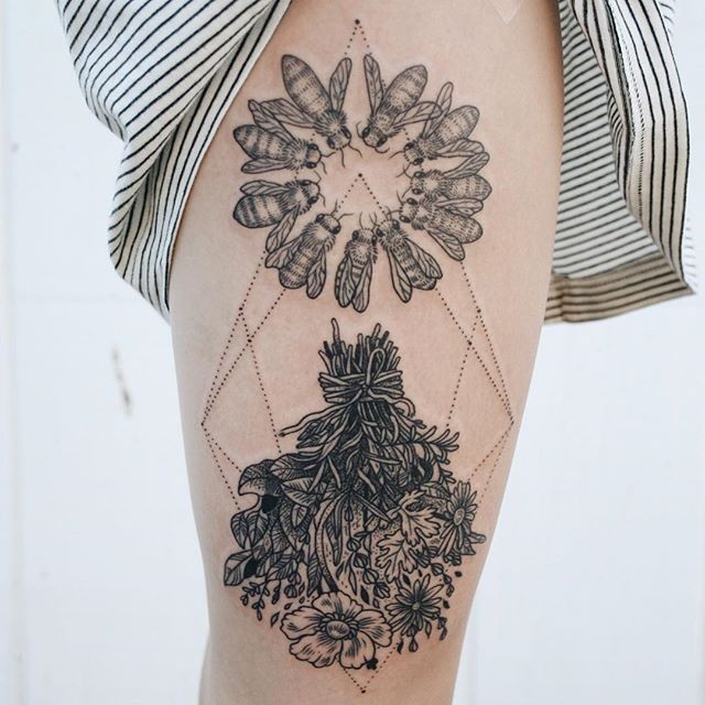 Big black ink thigh tattoo of bees and flowers