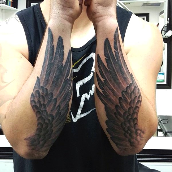 Big black ink wings tattoo on arm