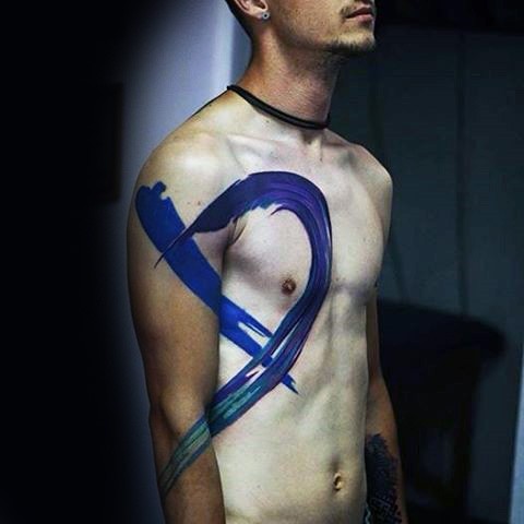 Big blue colored abstract ornament tattoo on chest and shoulder