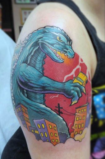 Big cartoon like colored Godzilla on shoulder area