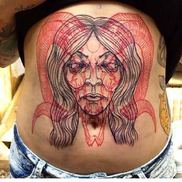 Big colored belly tattoo of demonic woman face with goat skull
