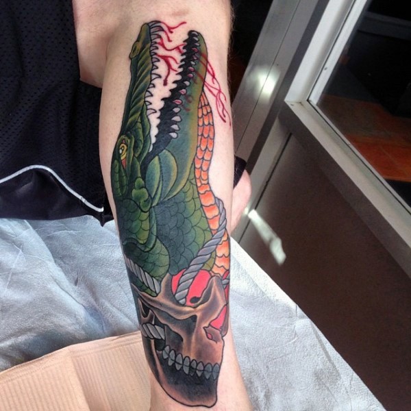 Big colored bloody alligator with skull tattoo on leg
