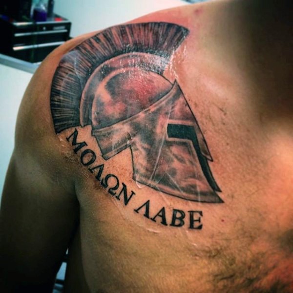 Big colored detailed Roman warrior helmet with lettering tattoo on shoulder