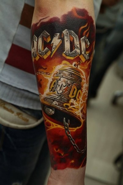 Big colored forearm tattoo of AC/DC emblem with bell