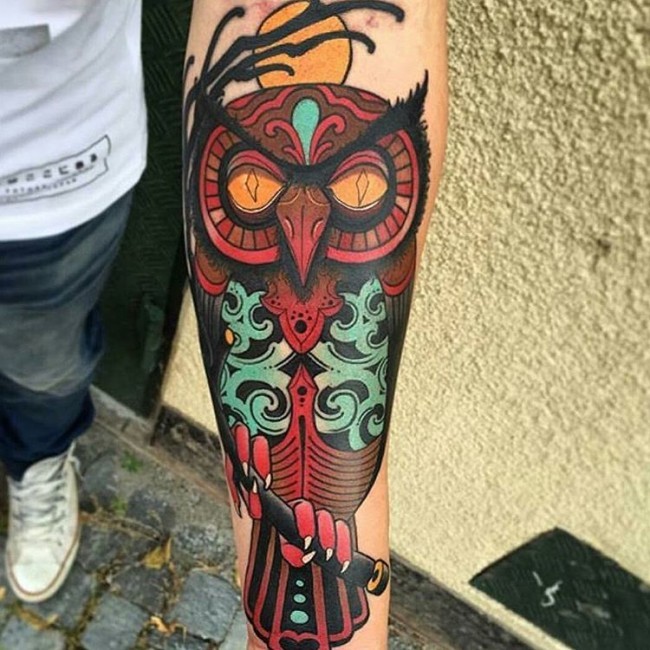 Big colored illustrative style forearm tattoo of cool owl