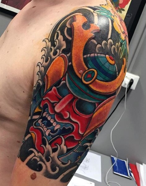 Big colored mystical samurai helmet tattoo on shoulder