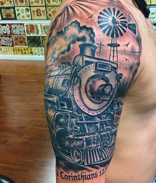 Big colored realistic old western train tattoo with lettering on shoulder