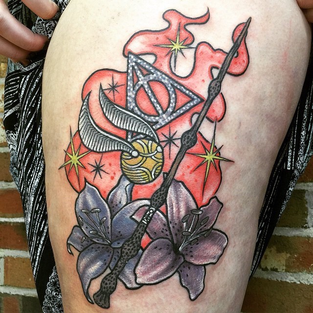 Big colorful Harry Potter themed tattoo on thigh with magic stick and quidditch ball