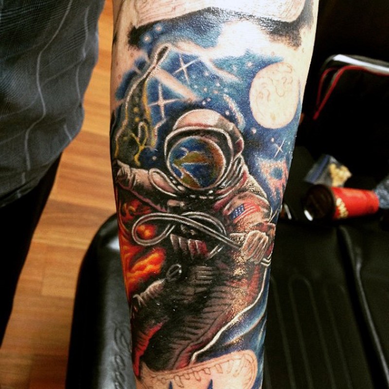 Big colorful space themed tattoo with astronaut on arm