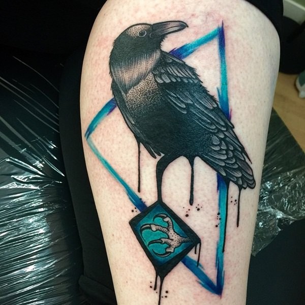 Big detailed black ink crow tattoo combined with blue triangle and mystical symbol