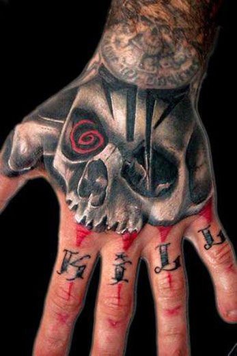 Big detailed colored mysterious skull with lettering tattoo on hand