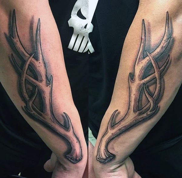 Big detailed looking engraving style deer horn tattoo on sleeve