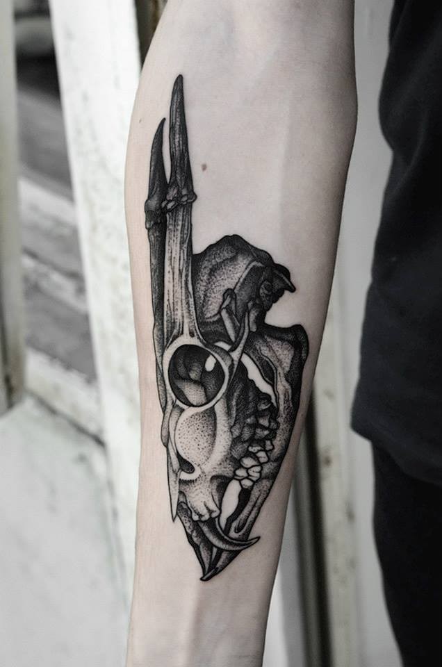 Big dot style forearm tattoo of fantastic animal skull